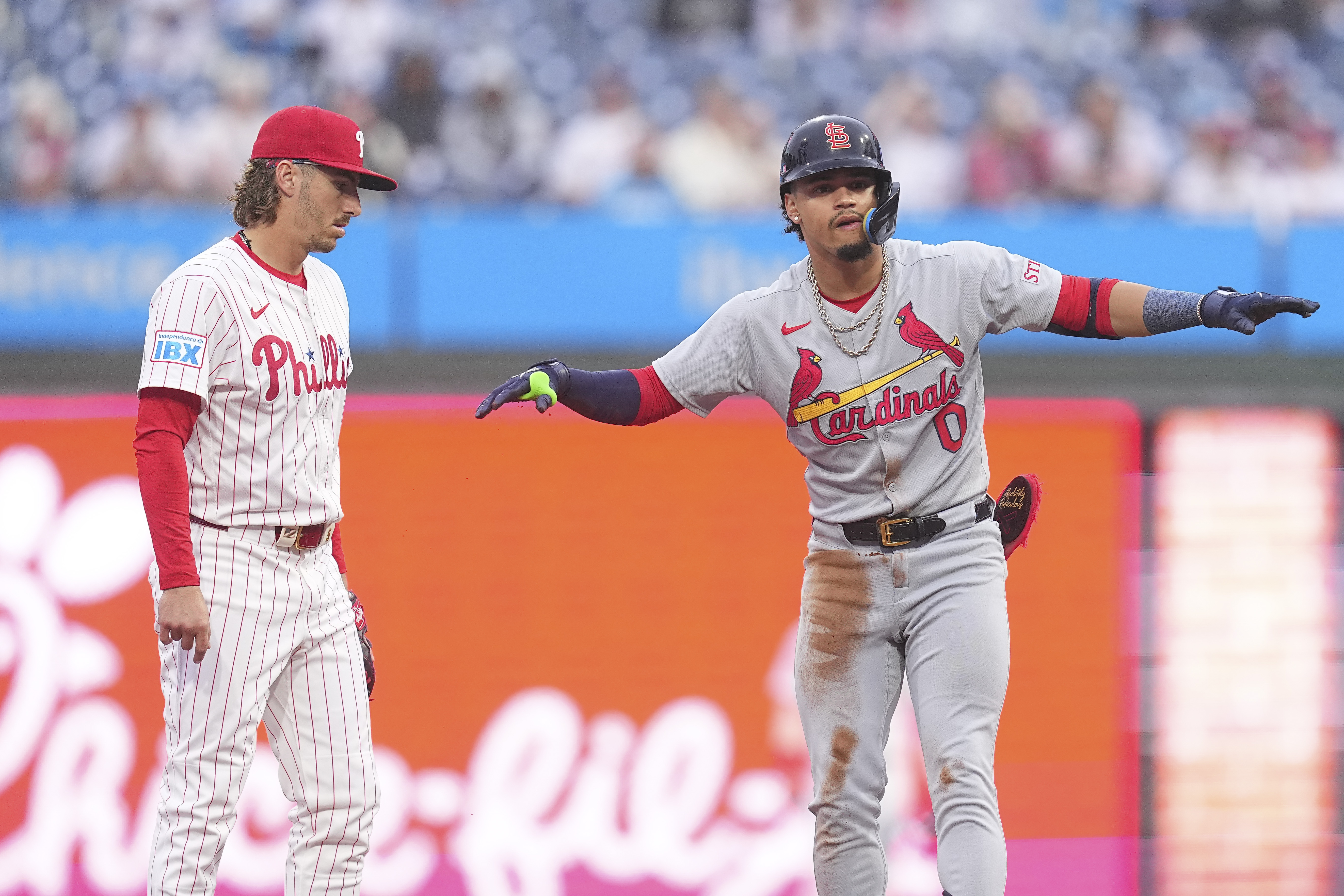 PHILADELPHIA, PENNSYLVANIA – MAY 14: Masyn Winn #0 of the St. Louis Cardinals reacts in front of Bryson Stott #5 of the Philadelphia Phillies after hitting a double in the top of the first inning during game two of a doubleheader at Citizens Bank Park on May 14, 2025 in Philadelphia, Pennsylvania. (Photo by Mitchell Leff/Getty Images)